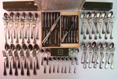 a lot of spoons and spoon knives on the table