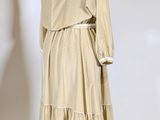 an image of a beige dress on a mannequin stand