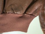 brown leather jacket with zippers on the back of a mannequin mannequin mannequin mannequin mannequin mannequin mannequin