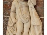 statue of a boy holding a bag on a marble block
