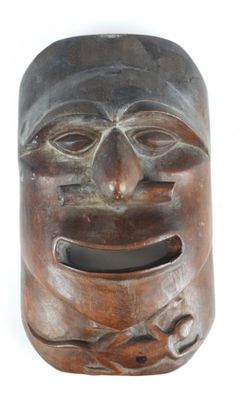 an image of a wooden mask on a white background