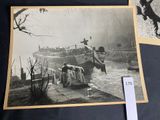 a black and white photo of a man on a boat