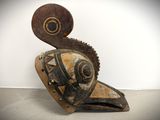 sculpture of a bird made of wood and metal on a white surface