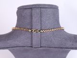 a close up of a mannequin with a gold chain on it