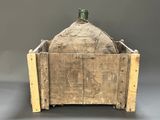 an old wooden crate with a bottle in it sitting on a table