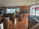 bottles of wine are lined up on the shelves in a wine shop
