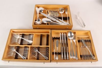 two wooden trays with silverware in them on a table
