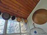 many hats hanging from the ceiling of this room