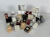 many different boxes of perfume on a white surface