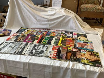 a lot of magazines on a table covered with a white cloth