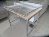 a table with a metal pan on it in a kitchen