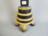 a black and yellow clock sitting on top of a stack of black and yellow boxes