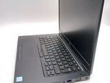a laptop computer sitting on a table with a keyboard