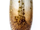 a glass vase that is sitting on a stand
