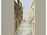 painting of a narrow street with buildings and a person walking down the street