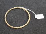 a close up of a rope bracelet with a tag on it