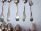a lot of silver spoons and spoon spoons on the table
