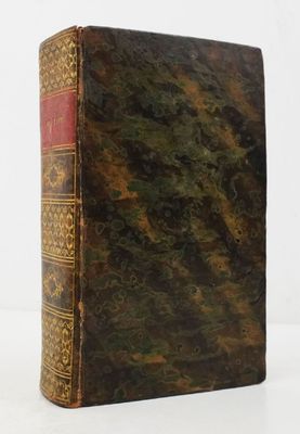 an old book sitting on top of a table next to a white background