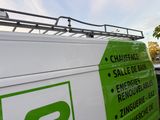 a white van with a green sign on the side of it