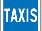 blue and white traffic sign with the word taxi written on it