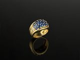a gold ring with blue sapphires and diamonds
