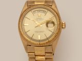 an image of a gold rolex watch on a white background
