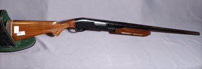 a close up of a rifle on a table with a hat on it