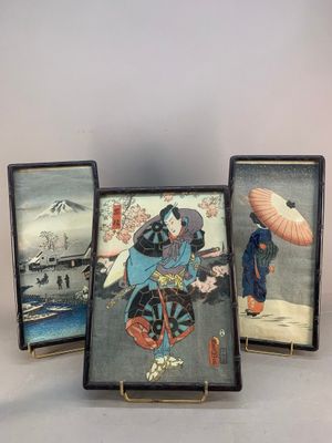 three framed pictures of a woman with an umbrella and a man with a parasol