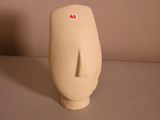 a white vase that has a red sticker on it