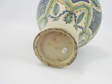 a blue and white vase sitting on a white surface