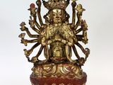 une image représentant une statue de Bouddha en or posée sur un socle rouge