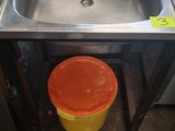 a sink and a trash can in the kitchen