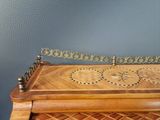 a wooden box with a decorative design on top of it