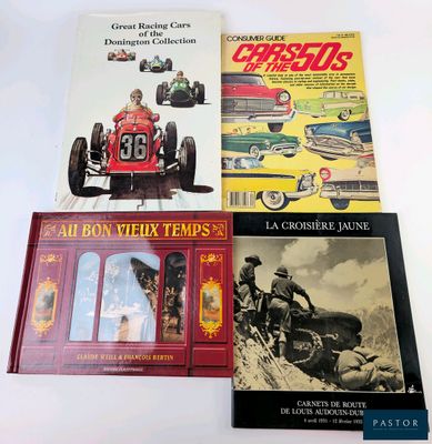 three books on a white table with a picture of a man driving a car