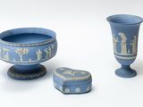 two blue vases and a small box on a white surface