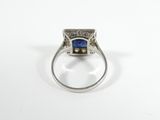 a close up of a ring with a blue stone in it