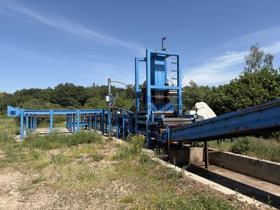 an image of a blue machine that is sitting in the grass