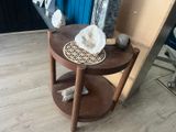 a wooden table with a basket on top of it next to a mirror