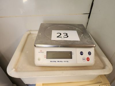a scale sitting on top of a stack of papers