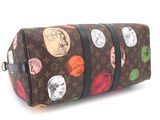 a brown and multicolored bag with a bunch of coins on it