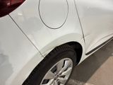 a close up of a white car parked in a parking lot