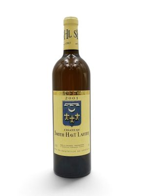 a bottle of wine sitting on top of a white table