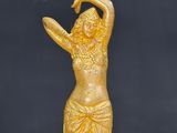an image of a statue of a woman in a gold dress