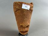 a small clay object with a tag on it