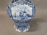 a blue and white vase with a ship on it