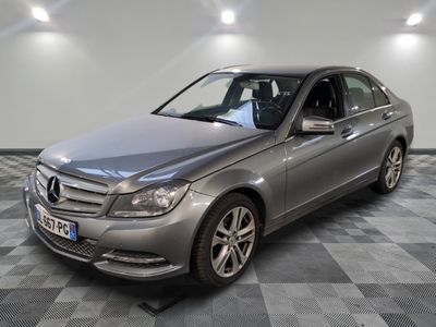 the mercedes c - class is parked on a checkered floor