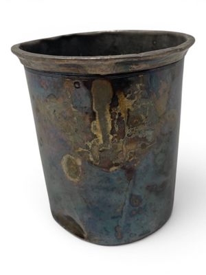a metal pot that has a rusted surface on it