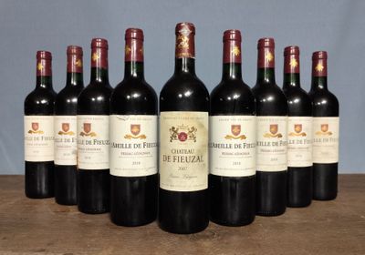 six bottles of red wine are lined up on a table