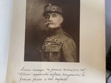 an old photo of a man in uniform with a pipe in his mouth