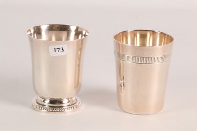 two silver cups with numbers on them sitting next to each other